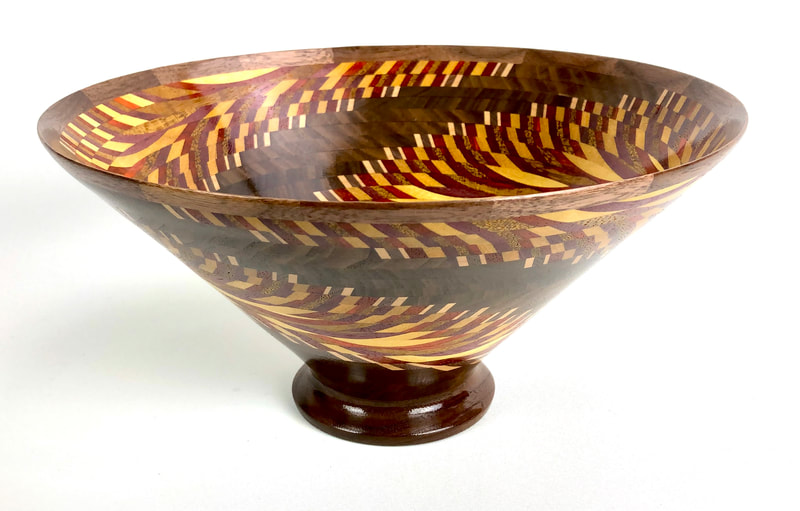 Artist: Philip DeCarlo.
 Intricately detailed vessels and boxes in exotic wood with accents of copper and resin.