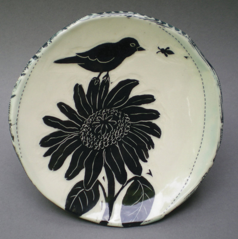 Artist: Rae Stark.
Functional and decorative porcelain pottery with hand-carved imagery.